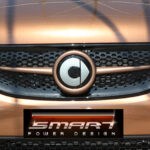 Front grille SLS in color hazel brown metallic with original Smart emblem for Smart Fortwo 453